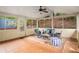 Inviting screened-in porch with terracotta floors, ceiling fan, and ample natural light at 2360 Elon Way, Decatur, GA 30033