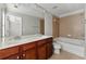 This bathroom features a dual sink vanity and tiled tub-shower combo at 2313 Millhaven St, Smyrna, GA 30080