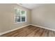 Neutral bedroom with wood-look flooring and a bright window at 2313 Millhaven St, Smyrna, GA 30080