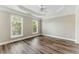 Bright bedroom with tray ceilings, ceiling fan, and two large windows at 2313 Millhaven St, Smyrna, GA 30080