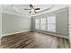 This bedroom features tray ceilings, a ceiling fan, luxury vinyl floors and many windows at 2313 Millhaven St, Smyrna, GA 30080