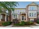 Charming townhome with brick accents, a welcoming front porch, and manicured landscaping at 2313 Millhaven St, Smyrna, GA 30080