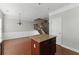Kitchen island near staircase with granite countertops and wood cabinetry at 2313 Millhaven St, Smyrna, GA 30080