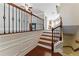 View of staircase with wood and iron railing near a kitchen and living area at 2313 Millhaven St, Smyrna, GA 30080