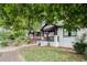 Street view of craftsman bungalow home with brick foundation, covered porch and manicured lawn at 554 Lawton Sw St, Atlanta, GA 30310