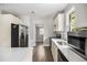 Modern kitchen with stainless steel appliances, white cabinets, and wood-look flooring at 554 Lawton Sw St, Atlanta, GA 30310