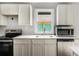 Bright kitchen featuring white cabinets, stainless steel appliances, and a modern countertop at 554 Lawton Sw St, Atlanta, GA 30310
