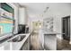 Modern kitchen with an island, stainless steel appliances, and wood-look flooring at 554 Lawton Sw St, Atlanta, GA 30310