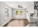 Open-concept living room with hardwood floors, natural light, and views of backyard at 554 Lawton Sw St, Atlanta, GA 30310