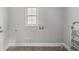 Empty room with wood-look flooring and a window at 554 Lawton Sw St, Atlanta, GA 30310