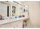 Bright bathroom featuring a large vanity with a single sink and a mirrored wall at 133 Maison Nw Pl, Atlanta, GA 30327