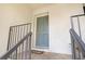 Close-up of the front door with a welcome mat and wrought iron railing at 133 Maison Nw Pl, Atlanta, GA 30327
