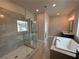 Bathroom with glass shower, soaking tub, and double sinks at 173 Basil St, Cumming, GA 30040