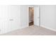 Bright bedroom with neutral carpet, walk-in closet and open bathroom doorway at 173 Basil St, Cumming, GA 30040