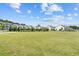 Sprawling green space in a meticulously landscaped community with townhomes on a sunny day at 173 Basil St, Cumming, GA 30040