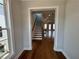 Inviting home entryway with hardwood floors, staircase, and open view into a large living space at 173 Basil St, Cumming, GA 30040