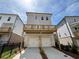 Exterior view of townhomes with garages and decks at 173 Basil St, Cumming, GA 30040