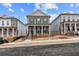 Charming two-story home featuring a covered porch, gray brick facade, and landscaped front yard at 173 Basil St, Cumming, GA 30040