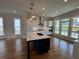 Modern kitchen featuring an island with white countertop, stainless steel appliances, and lots of natural light at 173 Basil St, Cumming, GA 30040