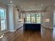 Bright kitchen features an island with marble countertop and windows overlooking the outdoors at 173 Basil St, Cumming, GA 30040