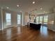 Spacious kitchen featuring island, white cabinets, and lots of light from large windows at 173 Basil St, Cumming, GA 30040