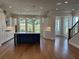 Modern kitchen featuring an island with white countertop, white cabinets and stainless steel appliances at 173 Basil St, Cumming, GA 30040