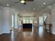 Open-concept living room showcasing hardwood floors, white cabinets, stainless steel appliances and a staircase at 173 Basil St, Cumming, GA 30040
