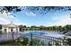 Community pool with a bath house and lounge chairs surrounded by colorful flowers and trees at 173 Basil St, Cumming, GA 30040