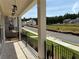 Street view from covered porch showing houses across the street and a partial view of the neighborhood at 173 Basil St, Cumming, GA 30040