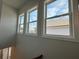 Stairwell windows letting in natural light, with a view of the neighborhood and blue sky at 173 Basil St, Cumming, GA 30040