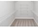 Walk-in closet featuring carpeted floor and adjustable shelving at 173 Basil St, Cumming, GA 30040