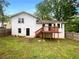 Backyard with a wooden deck, white siding, and a fenced-in yard with mature trees at 2067 Wellborn Close, Lithonia, GA 30058