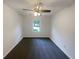 Bright bedroom featuring neutral walls, carpet flooring, a ceiling fan, and a window overlooking the front yard at 2067 Wellborn Close, Lithonia, GA 30058