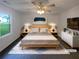 Bright bedroom with ceiling fan, side tables and lamps, and lots of natural light at 2067 Wellborn Close, Lithonia, GA 30058