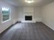 Living room featuring gray carpet flooring, a painted brick fireplace, and natural light from a window at 2067 Wellborn Close, Lithonia, GA 30058