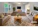 Bright living room with hardwood floors, neutral furniture, and a large window with lots of natural light at 2067 Wellborn Close, Lithonia, GA 30058