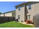 Private fenced backyard with a well-maintained lawn and patio seating, perfect for outdoor enjoyment at 4925 Longview Walk, Decatur, GA 30035