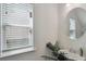 Bright bathroom featuring a window with blinds, round mirror, and a decorative plant at 4925 Longview Walk, Decatur, GA 30035