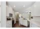 Open kitchen with stainless appliances, white cabinets, tile backsplash, and hardwood flooring at 4925 Longview Walk, Decatur, GA 30035
