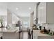 Airy kitchen boasts white cabinets, stainless steel appliances, wood floors and ample counter space at 4925 Longview Walk, Decatur, GA 30035
