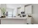 Bright kitchen featuring white cabinets, stainless steel appliances, and a sleek breakfast bar at 4925 Longview Walk, Decatur, GA 30035