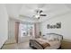 Bright bedroom with tray ceiling, ceiling fan, large window and modern decor at 4925 Longview Walk, Decatur, GA 30035