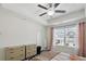 Primary bedroom with a ceiling fan, neutral paint, and natural light from the window at 4925 Longview Walk, Decatur, GA 30035
