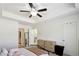Cozy primary bedroom featuring a tray ceiling, ceiling fan, and neutral decor at 4925 Longview Walk, Decatur, GA 30035