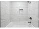 Refined bathroom with white subway tiles, modern shower fixture, and built-in niche for essentials at 2930 Parc Lorraine, Lithonia, GA 30038