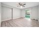 Bright bedroom features wood flooring, a fan and large window allowing for natural light at 2930 Parc Lorraine, Lithonia, GA 30038
