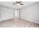 Bedroom featuring wood flooring, fan, and closet doors at 2930 Parc Lorraine, Lithonia, GA 30038