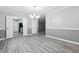 Dining area featuring modern vinyl flooring, fresh paint, and access to the kitchen at 2930 Parc Lorraine, Lithonia, GA 30038