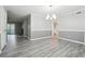 Elegant dining area with modern flooring, chandelier, and access to the living room at 2930 Parc Lorraine, Lithonia, GA 30038