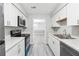 Modern kitchen featuring white cabinets, countertops, with stainless steel appliances at 2930 Parc Lorraine, Lithonia, GA 30038